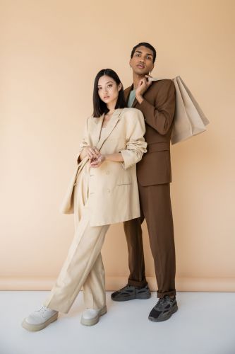 Two stylish residents posing in coordinated neutral outfits at The Meridian.