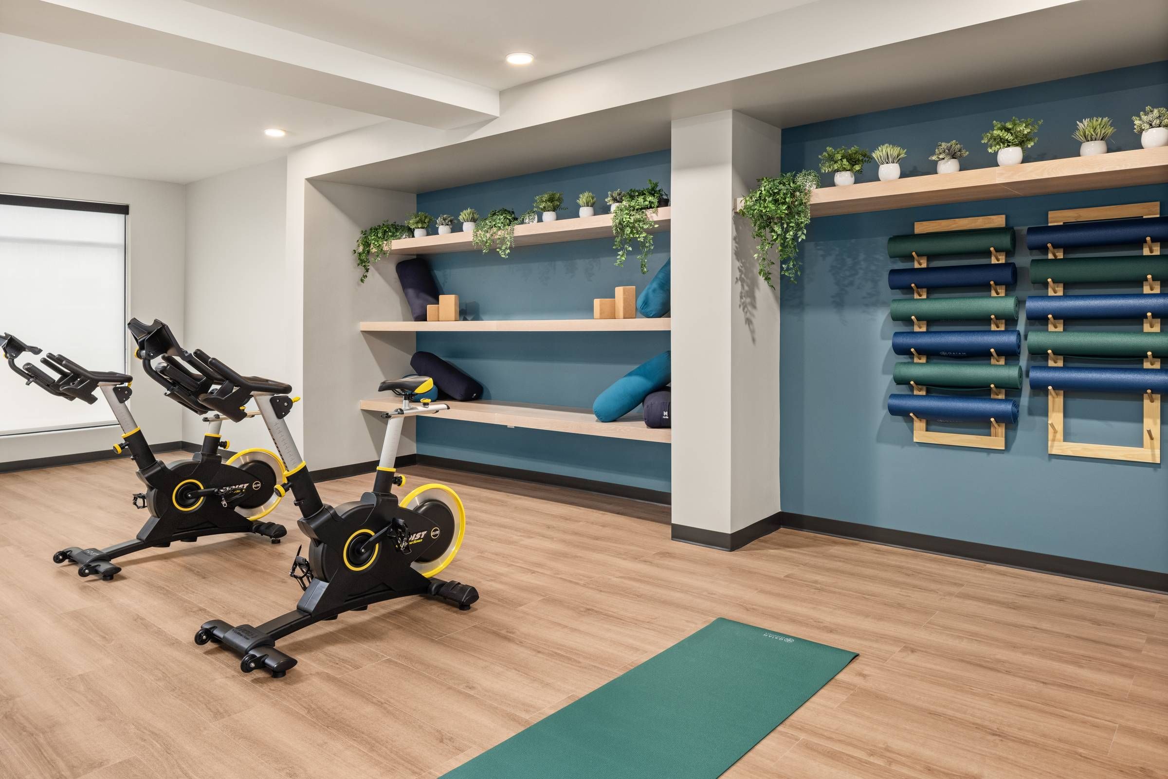 The Meridian apartments group fitness studio with yoga mats and stationary bikes.