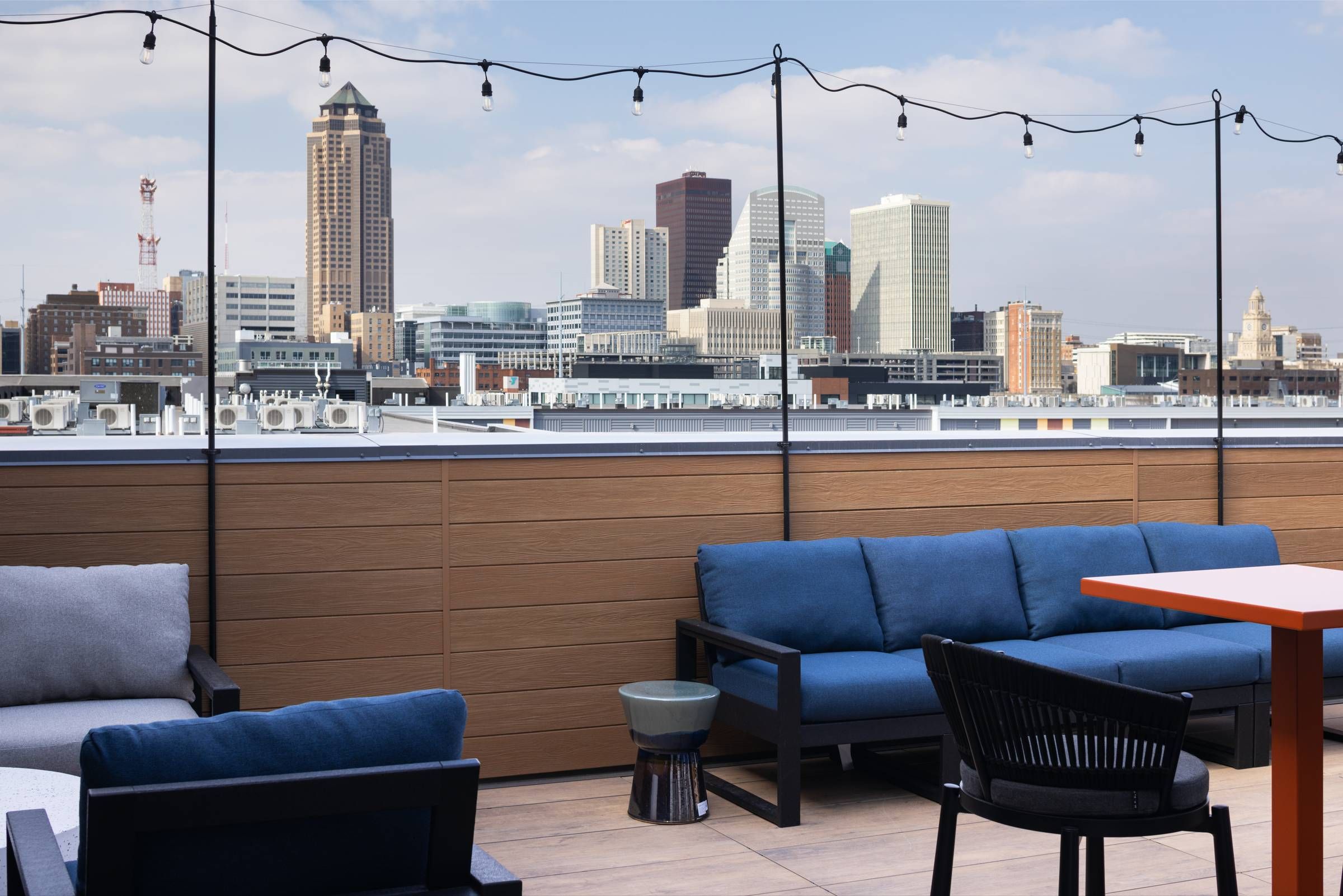 The Meridian Apartments rooftop deck with lounge seating and views of city skyline