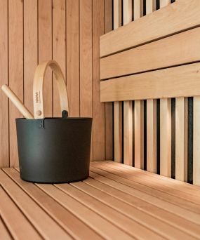 Contemporary Sauna at The Meridian showcasing a wooden deck with a stylish lounge chair and a planter.