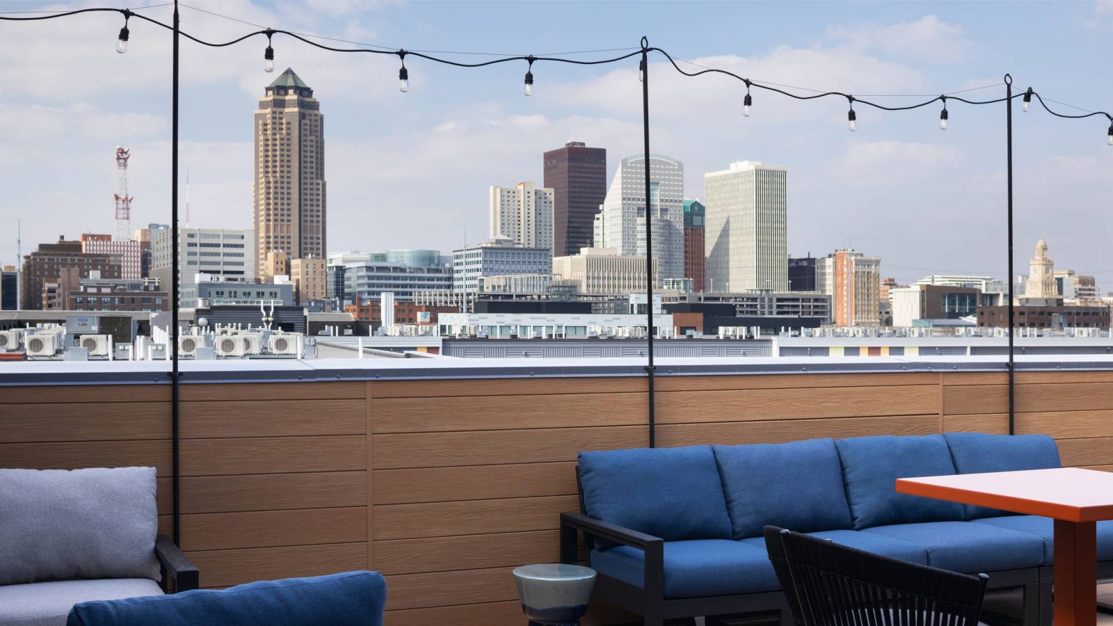 The Meridian Apartments rooftop deck with lounge seating and views of city skyline
