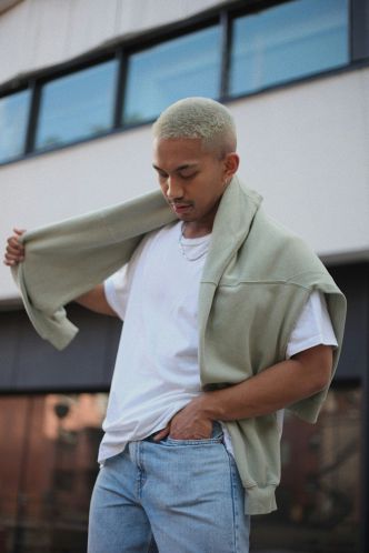 young man posing with a hoodie outside of the meridian