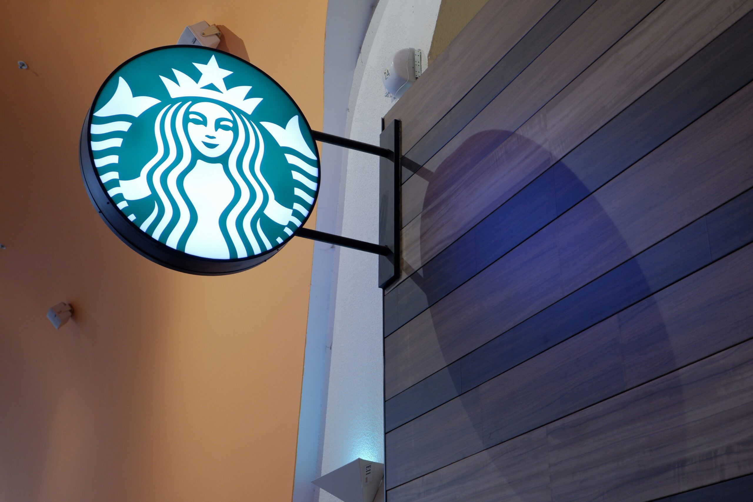 Starbucks sign on a wooden wall